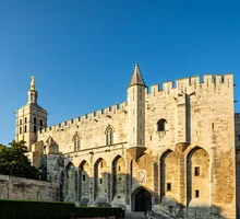 A grand historic palace framed by a bright southern sky